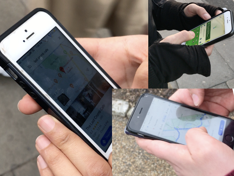 Three hands holding mobile phones with navigation apps open