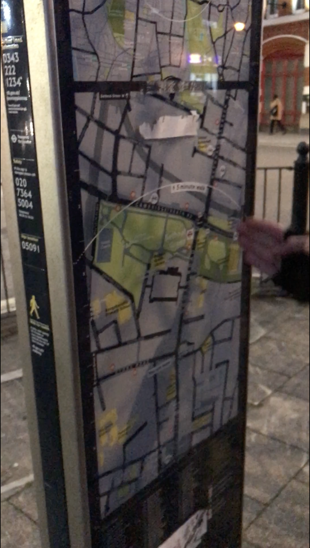 A hand gesturing to a street map